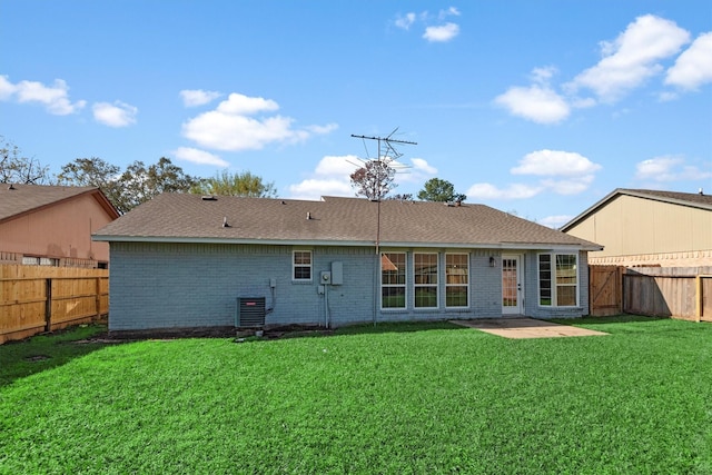 rear view of property featuring a patio, central AC unit, and a lawn