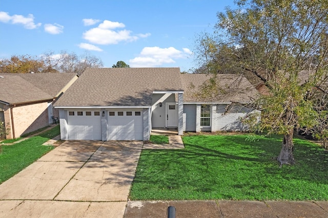 view of front of house with a garage and a front yard