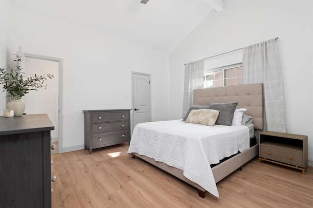 bedroom with ceiling fan, beamed ceiling, high vaulted ceiling, and light wood-type flooring