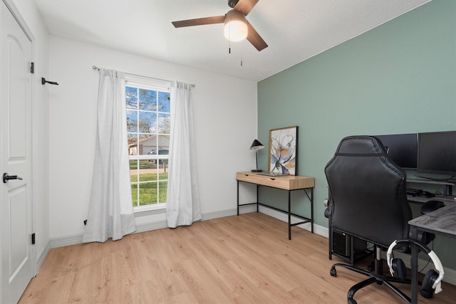 home office with ceiling fan and light hardwood / wood-style floors