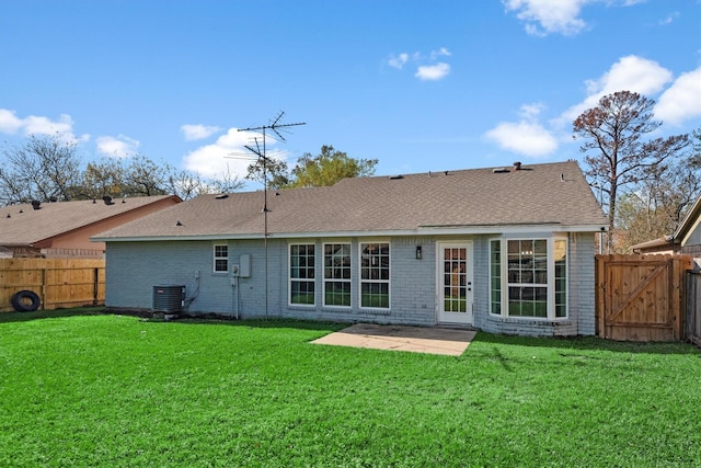 back of house with cooling unit, a patio area, and a yard