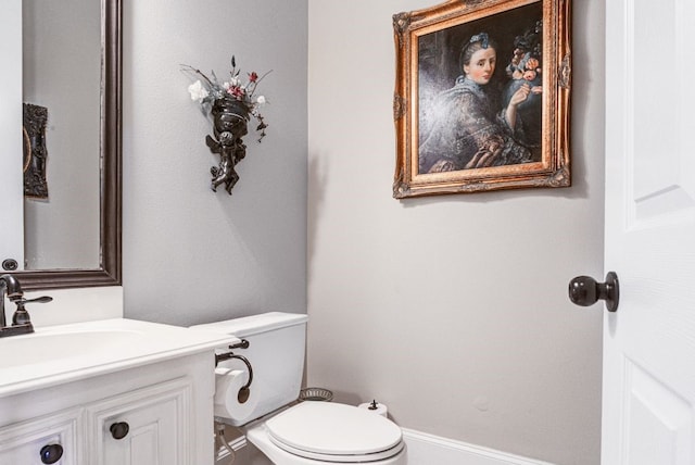 bathroom featuring toilet and vanity