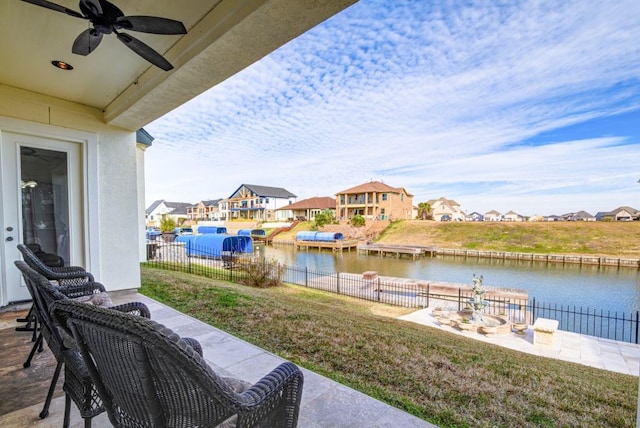 view of patio featuring ceiling fan and a water view