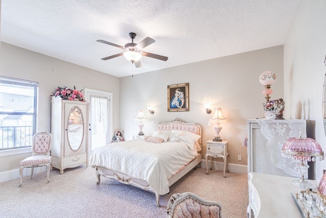 carpeted bedroom with ceiling fan and a textured ceiling