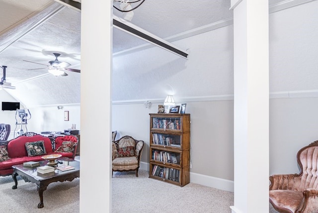 living room with ceiling fan, a textured ceiling, vaulted ceiling, and carpet