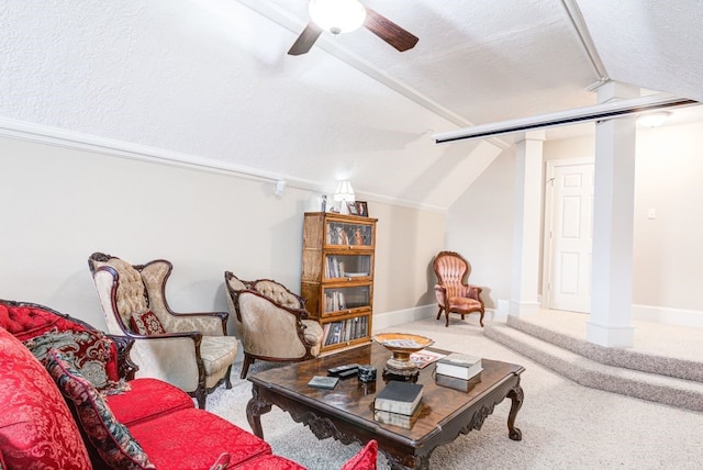 interior space with ceiling fan, a textured ceiling, carpet floors, and lofted ceiling