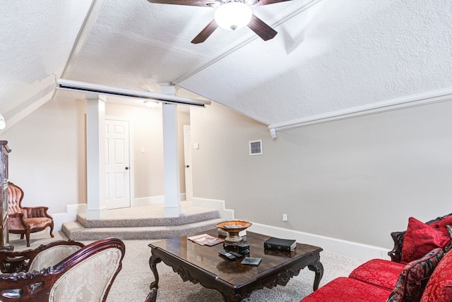 carpeted living room featuring ceiling fan, a textured ceiling, and lofted ceiling