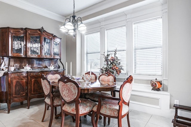 dining area featuring a notable chandelier, ornamental molding, and light tile patterned flooring