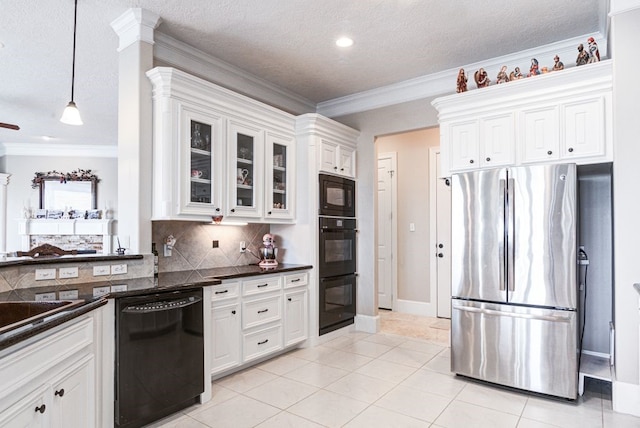 kitchen with decorative light fixtures, black appliances, white cabinets, and light tile patterned floors