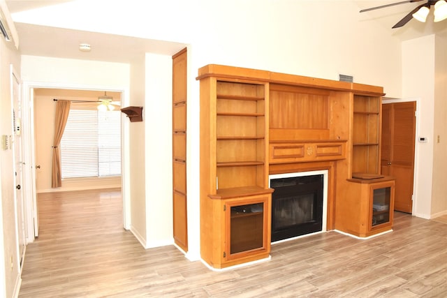 unfurnished living room featuring ceiling fan and light hardwood / wood-style flooring