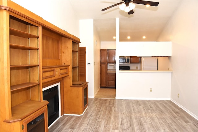 unfurnished living room with ceiling fan and light wood-type flooring