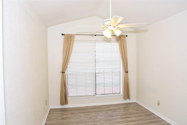 spare room featuring ceiling fan, light hardwood / wood-style flooring, and vaulted ceiling