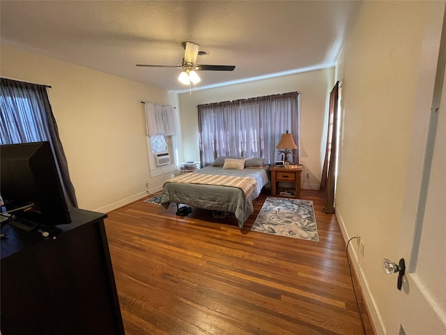 bedroom featuring ceiling fan and dark wood-type flooring