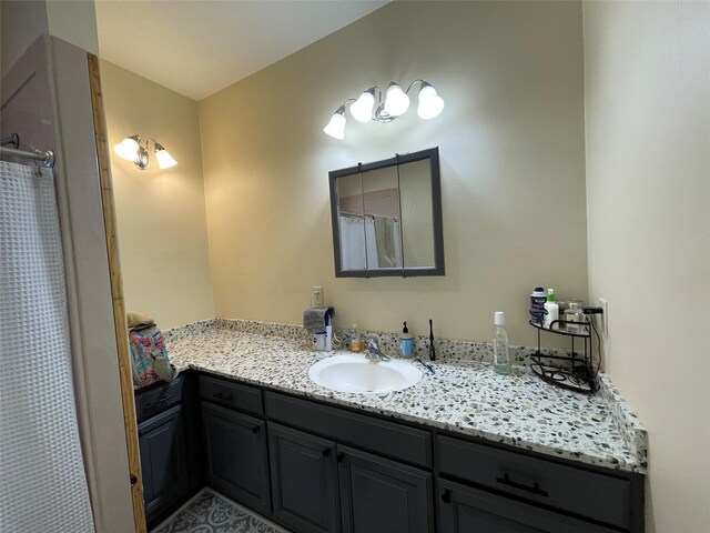 bathroom with curtained shower and vanity