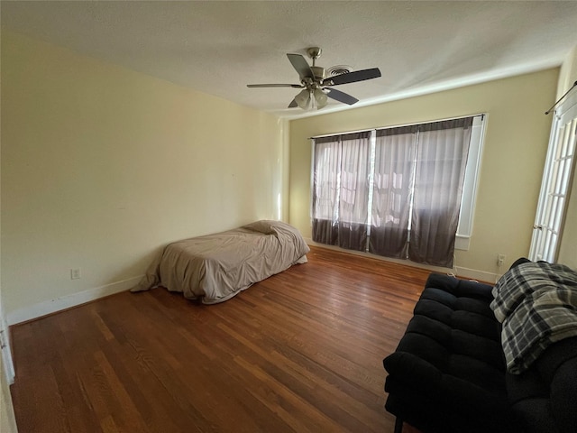 bedroom featuring dark hardwood / wood-style floors and ceiling fan