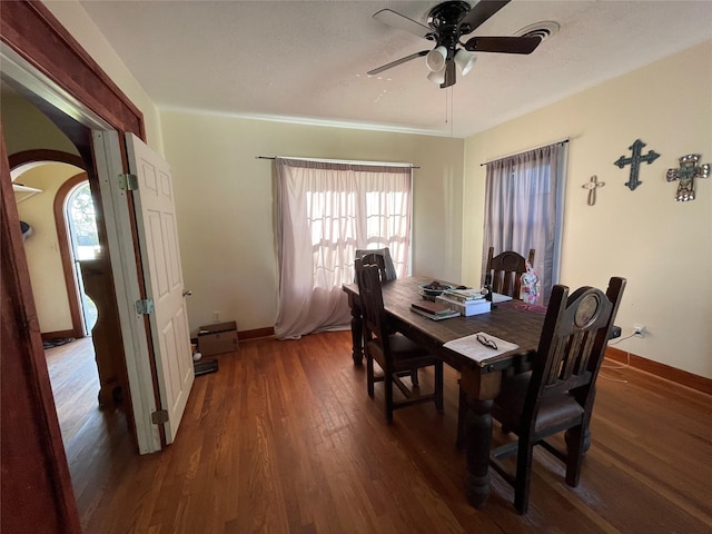 dining room with dark hardwood / wood-style flooring and ceiling fan