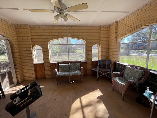 sunroom / solarium with ceiling fan and coffered ceiling