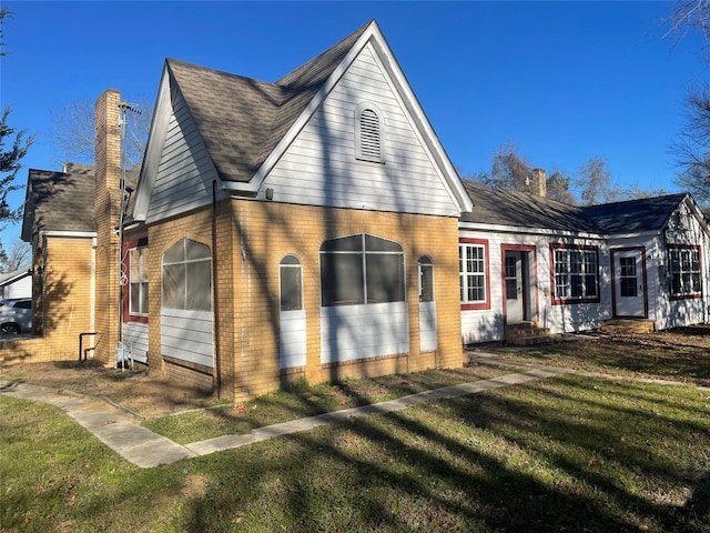 view of side of home featuring a yard