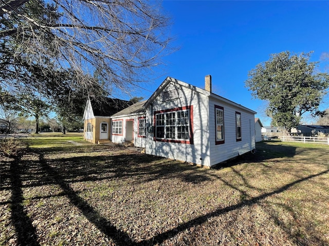 view of property exterior with a lawn