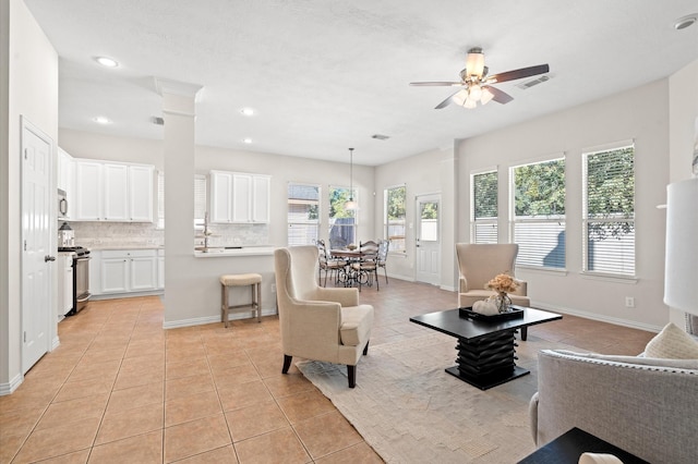 living room featuring ceiling fan and light tile patterned flooring