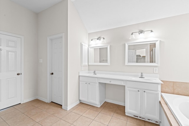 bathroom with tile patterned flooring, vanity, and a washtub