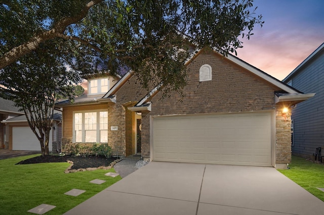 view of front facade with a lawn and a garage