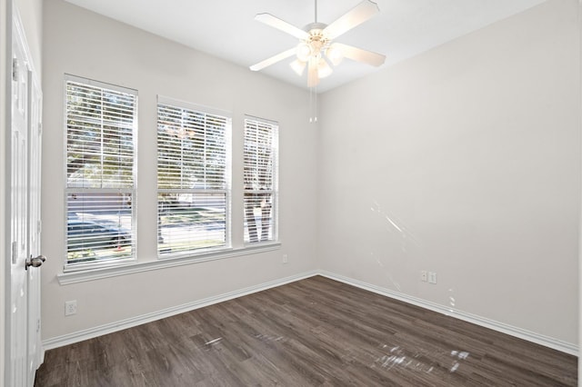 empty room with dark hardwood / wood-style floors and ceiling fan