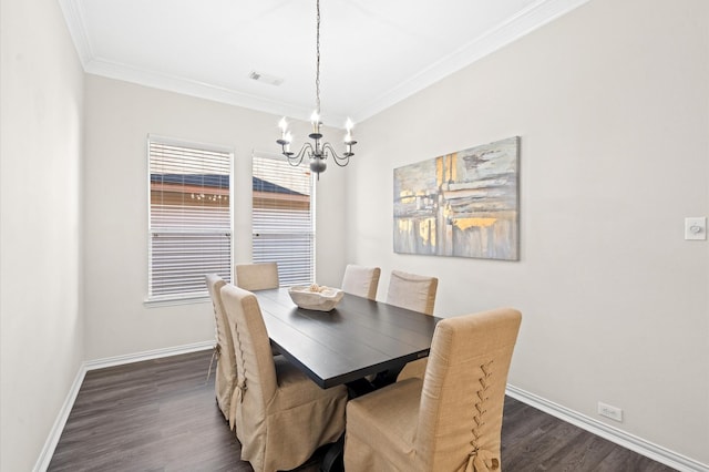 dining room featuring a chandelier, dark hardwood / wood-style floors, and crown molding