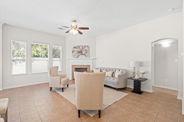 tiled living room with ceiling fan