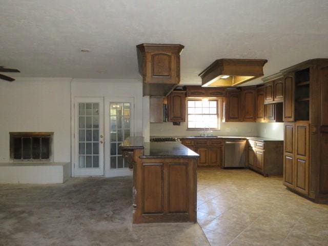 kitchen featuring french doors, sink, stainless steel dishwasher, ceiling fan, and a kitchen island