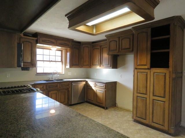 kitchen with light tile patterned floors, stainless steel dishwasher, and sink