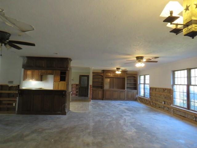 unfurnished living room featuring ceiling fan