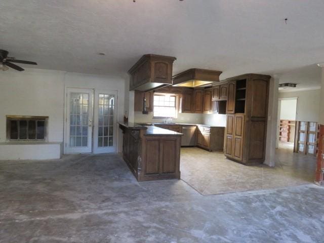 kitchen featuring stainless steel dishwasher, ceiling fan, dark brown cabinetry, and kitchen peninsula