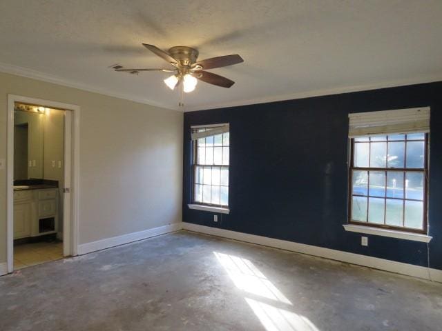 empty room with ceiling fan, ornamental molding, and concrete flooring