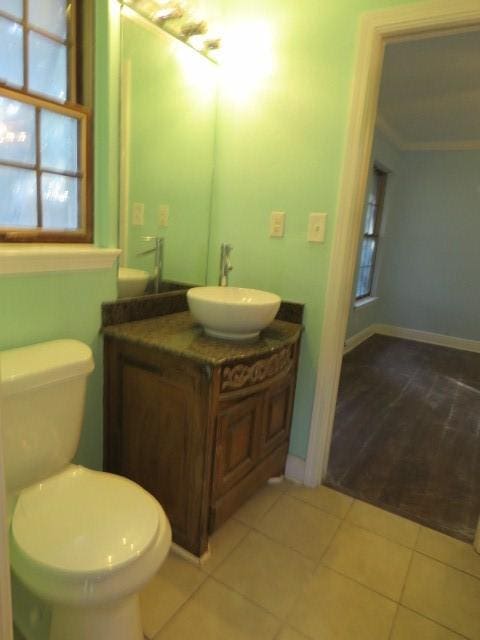 bathroom featuring tile patterned floors, vanity, and toilet