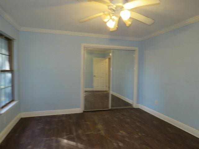 interior space featuring dark wood-type flooring, ceiling fan, and ornamental molding