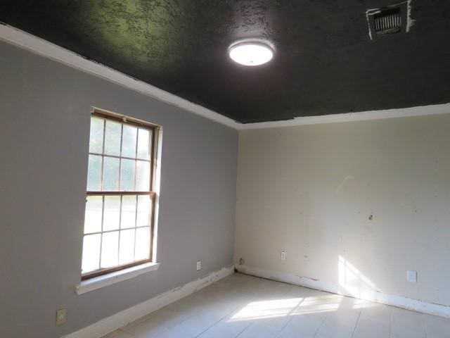 unfurnished room with crown molding