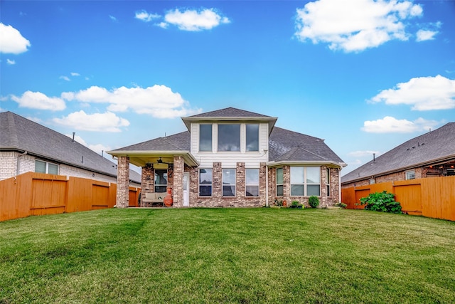 back of property with a lawn and ceiling fan