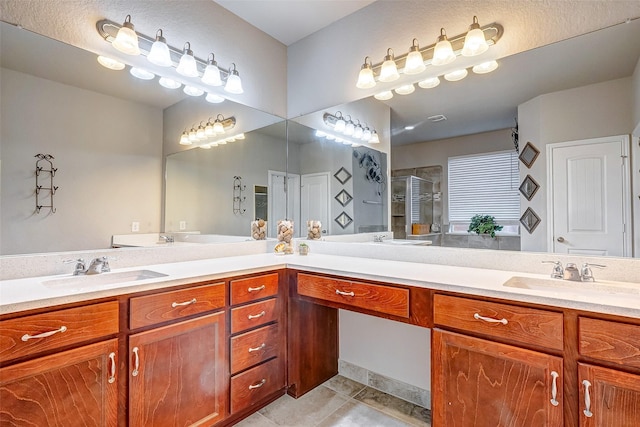 bathroom featuring tile patterned floors, vanity, and walk in shower