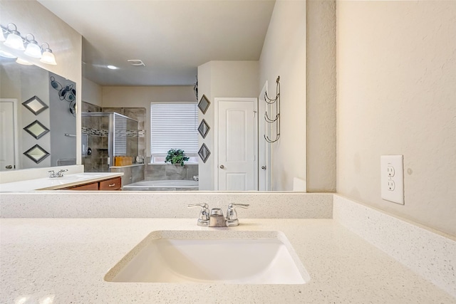 bathroom featuring plus walk in shower and vanity