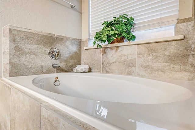 bathroom featuring tiled tub