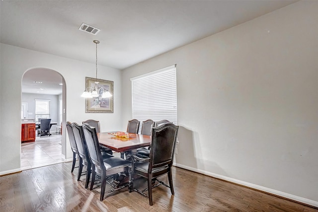 dining room with a chandelier and light hardwood / wood-style flooring