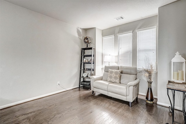 sitting room with wood-type flooring