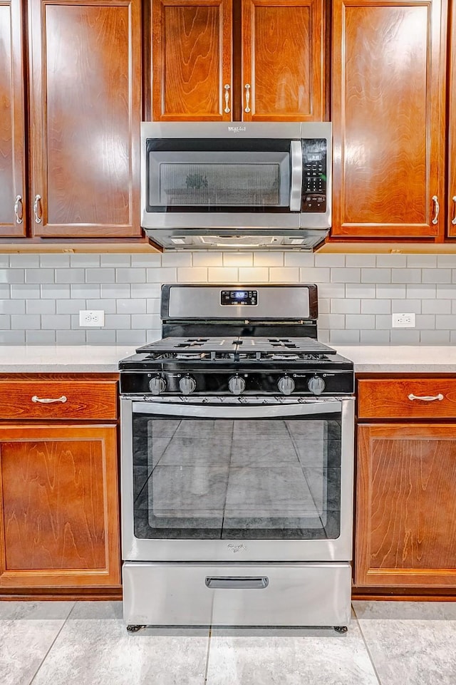 kitchen with tasteful backsplash and stainless steel appliances