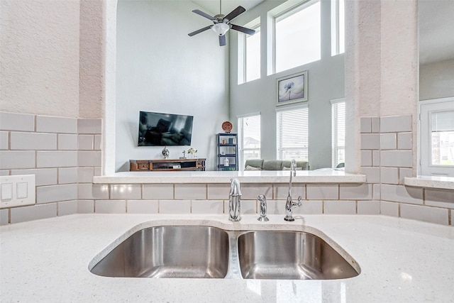 kitchen with plenty of natural light, sink, and light stone countertops