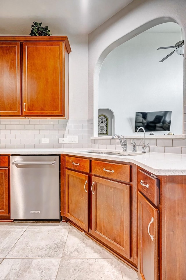 kitchen featuring tasteful backsplash, dishwasher, ceiling fan, light tile patterned floors, and sink