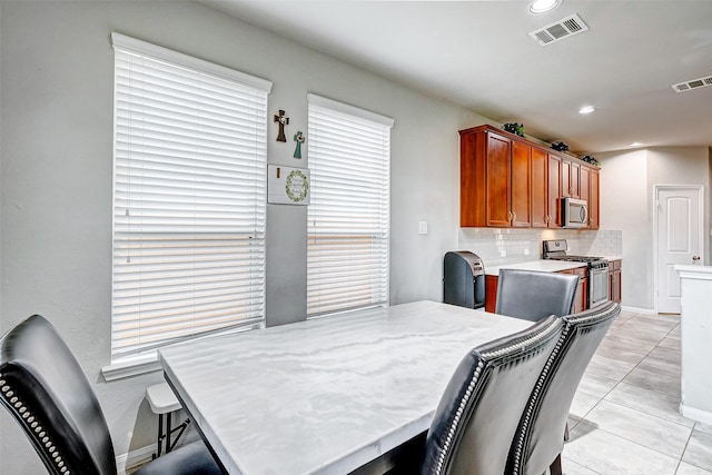 dining area with light tile patterned flooring