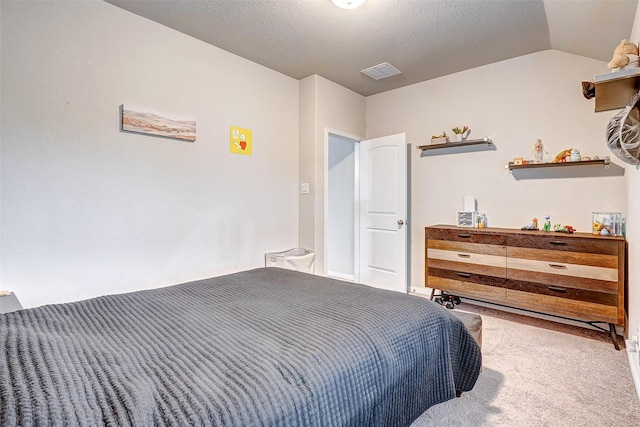 carpeted bedroom featuring a textured ceiling and lofted ceiling