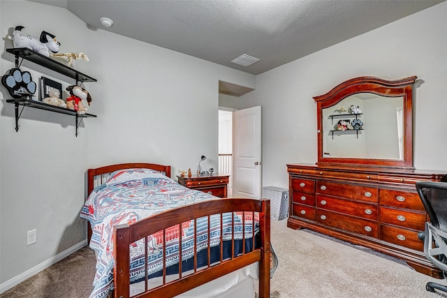 bedroom featuring carpet floors and a textured ceiling