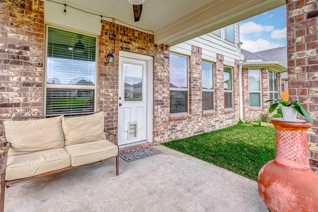 doorway to property featuring ceiling fan and a patio area